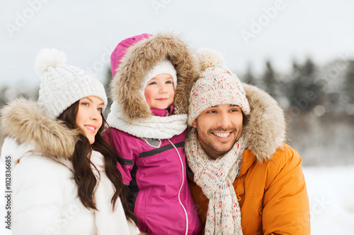 happy family with child in winter clothes outdoors