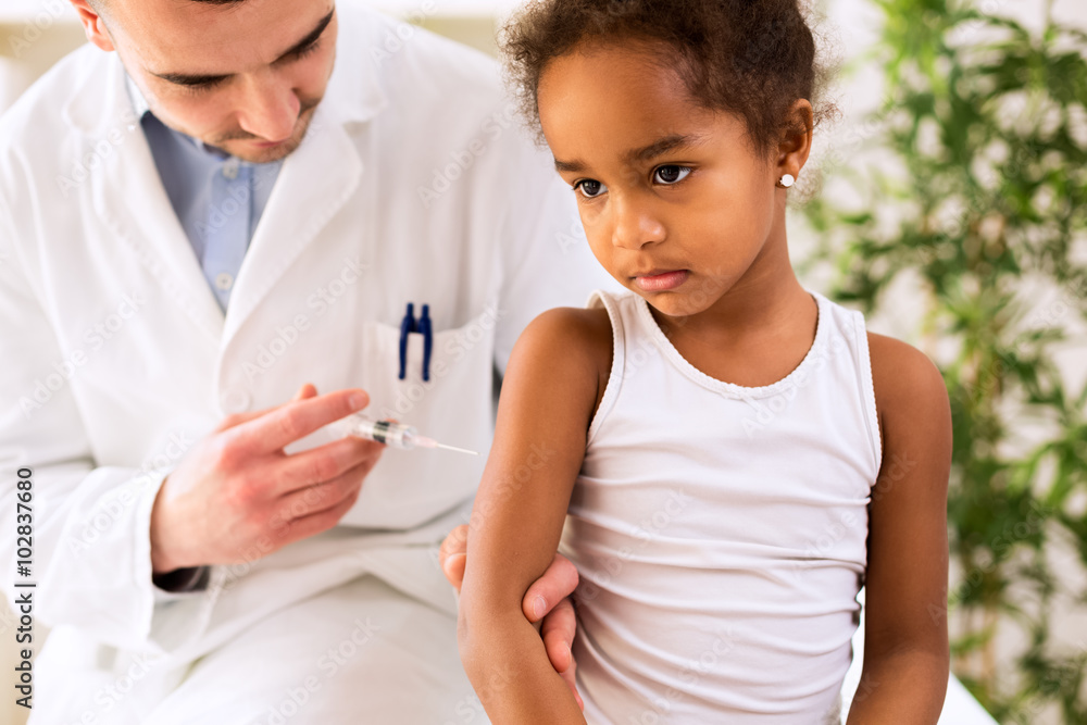 Medical doctor injecting a vaccine into the arm of a patient Medical doctor injecting a vaccine into the arm of a patient