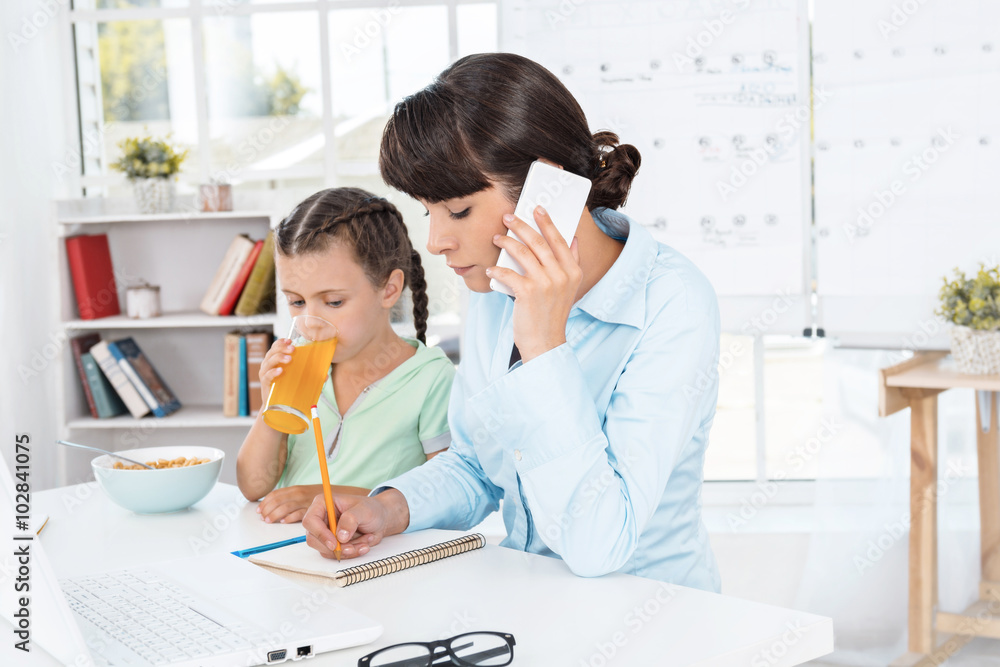 Business woman and daughter while working day Business woman and daughter while working day