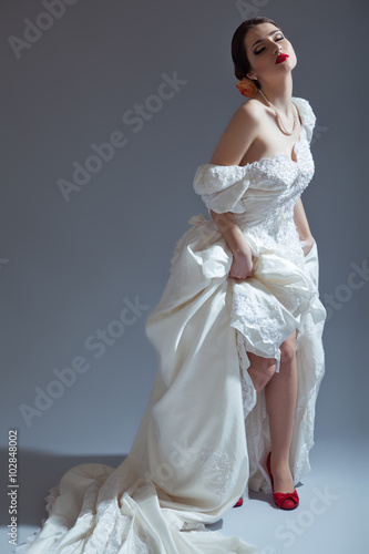 portrait of Beautiful bride in studio, gray background 