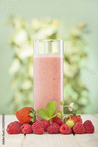 smoothie of berries on the table in the garden