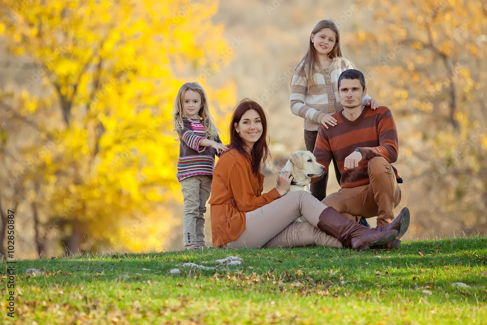 Fototapeta premium Happy family on nature with a labrador