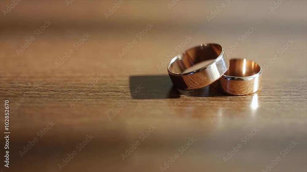 Gold Rings Lie on a Wooden Table Gold Rings Lie on a Wooden Table