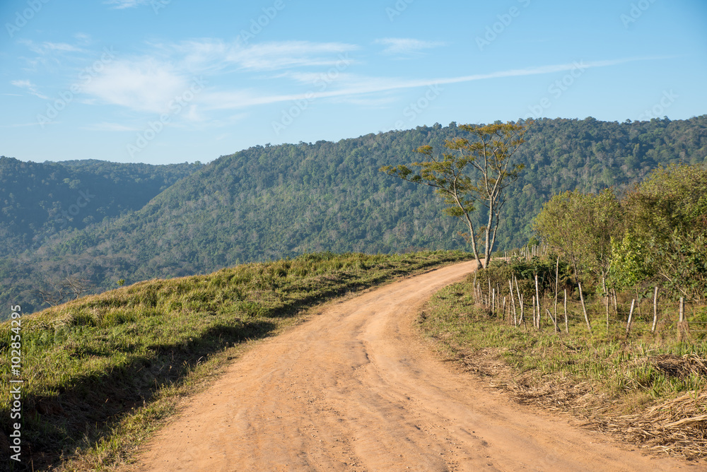 Curve dirt road in the mountain.