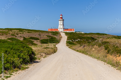 The dirt road leading to the Espichel Cape lighthouse. Built during the 18th century is one of the oldest lighthouses in Portugal and guides boats and ships in the Atlantic Ocean. Sesimbra, Portugal.