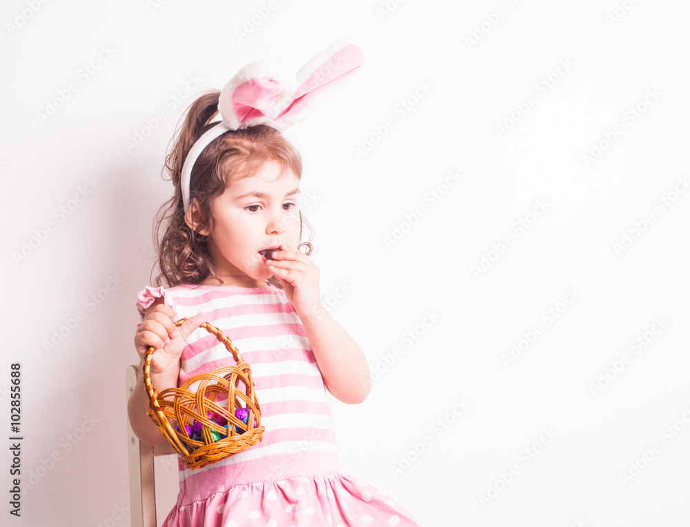 Girl eats a chocolate eggs Girl eats a chocolate eggs