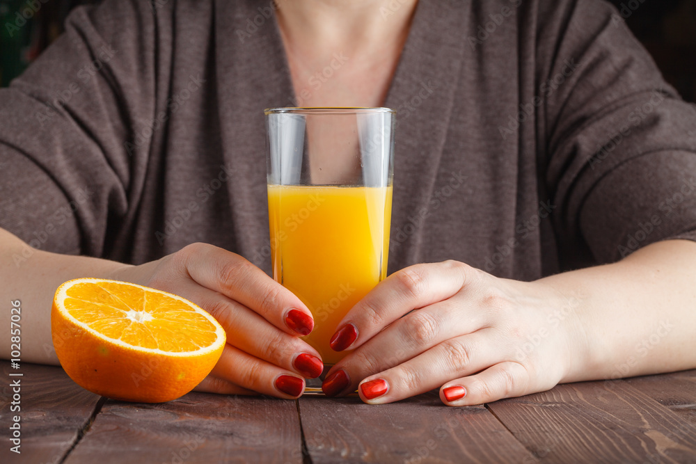 woman hand holding glass of orange juice woman hand holding glass of orange juice