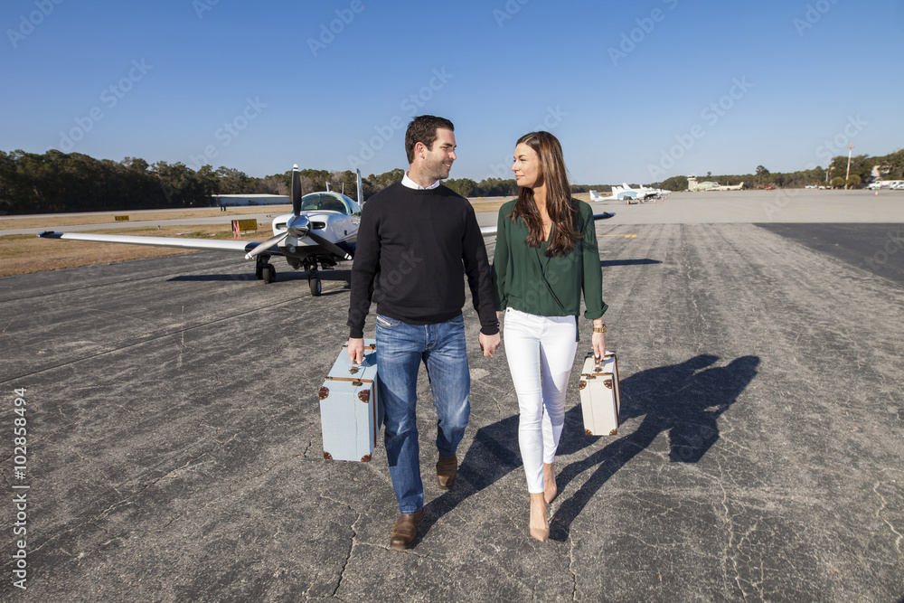 Trendy young couple with plane Trendy young couple with plane