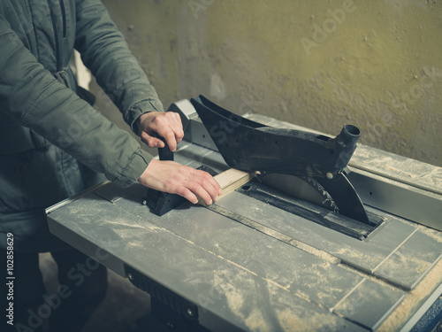 Young person operating tablesaw photo