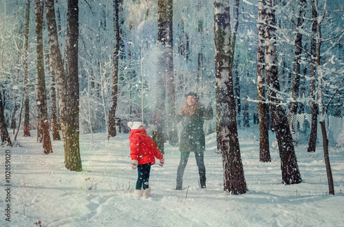 Fototapeta Naklejka Na Ścianę i Meble -  Children play in snowy forest.
