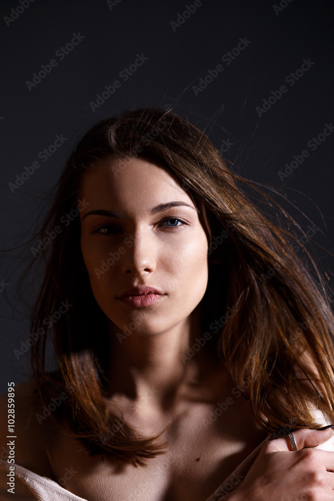 Portrait of beautiful brunette woman with natural look and without makeup on black background Portrait of beautiful brunette woman with natural look and without makeup on black background