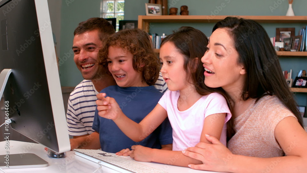 Family using computer together Family using computer together