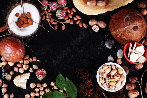 Background nuts on top of black, space, spice, food, almonds, coconut, peanuts, cashews, walnuts, pecans
