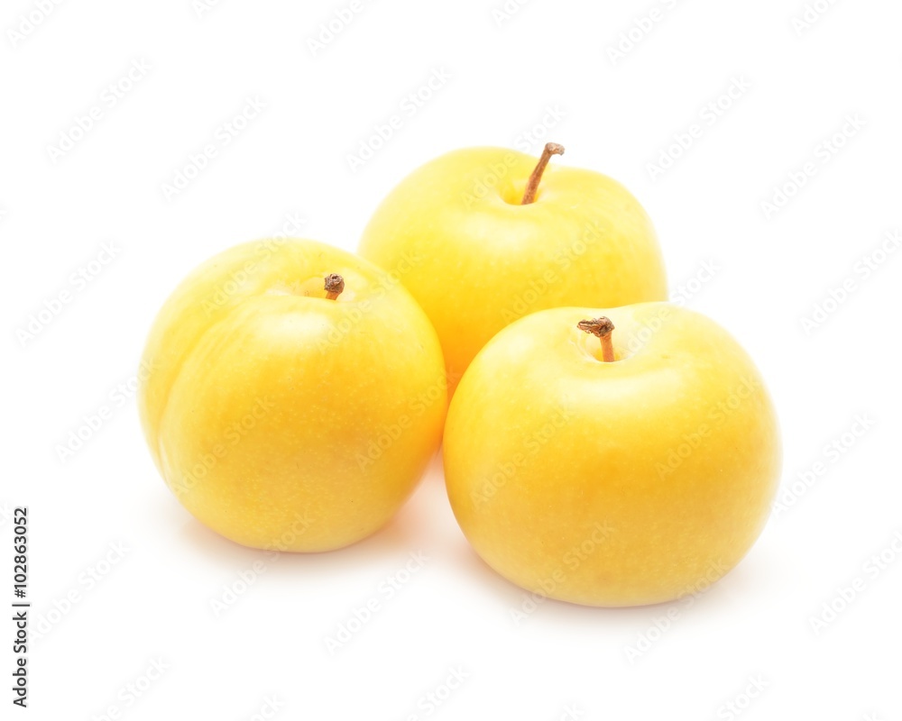 Three yellow plums isolated on white background