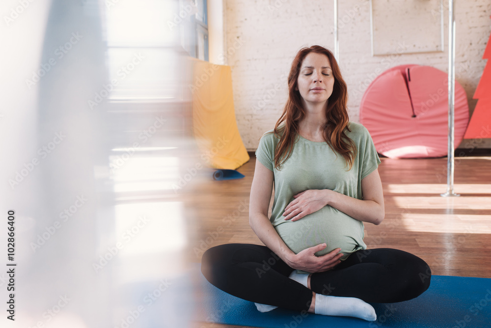 Pregnant woman doing yoga Pregnant woman doing yoga
