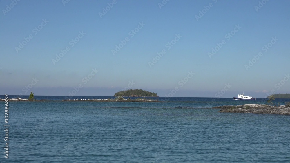 White boat approaching an island White boat approaching an island