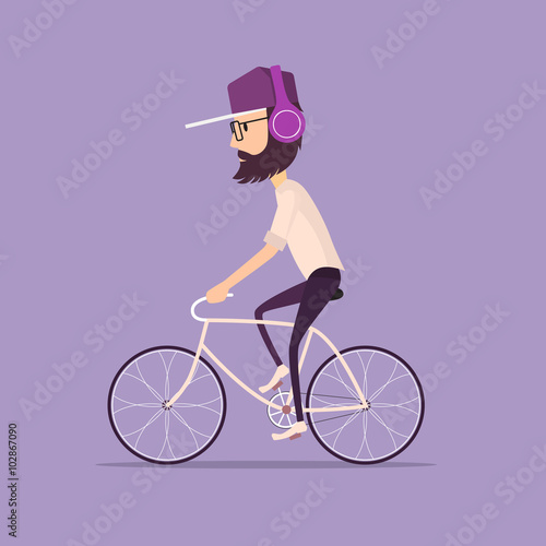 Hipster man in a baseball cap riding a vintage bicycle. 
Guy listening to music with modern purple headphones wearing light shirt and tight black jeans and trendy glasses.