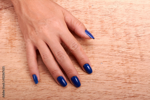 Woman hands with blue manicure and nail polish