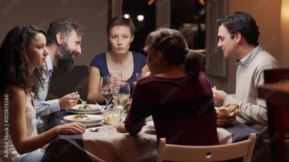 Group of young people dinning together. The camera moves. 4K, UHD Group of young people dinning together. The camera moves. 4K, UHD