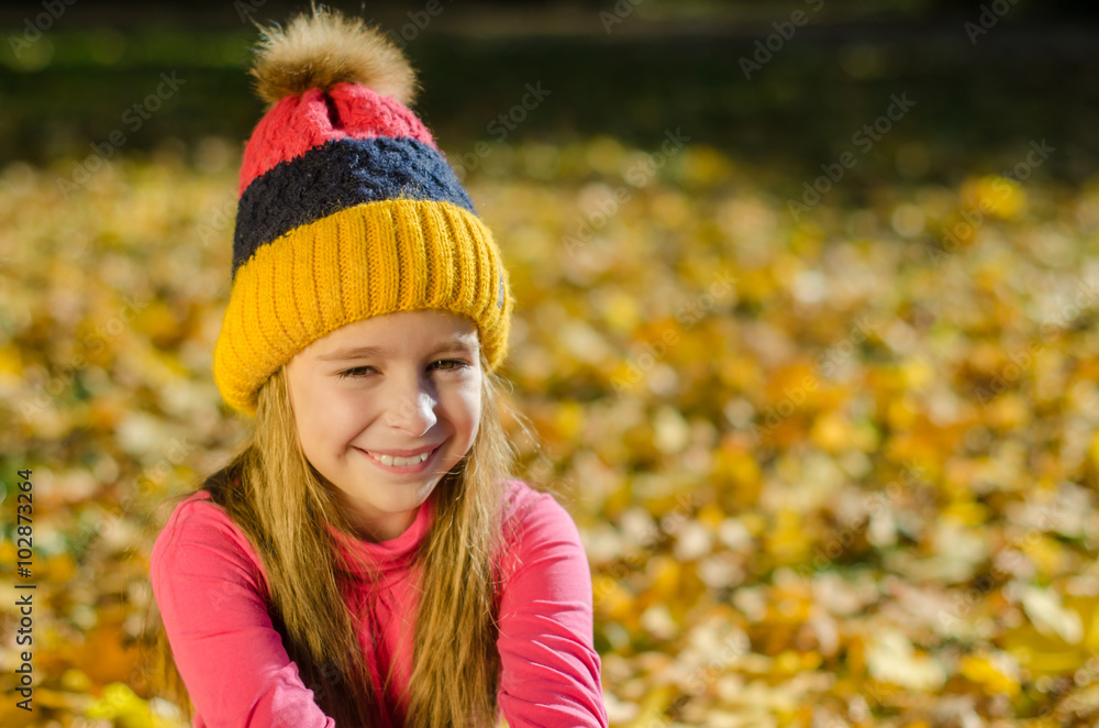 Pretty smiling girl with yellow leaves on the background Pretty smiling girl with yellow leaves on the background