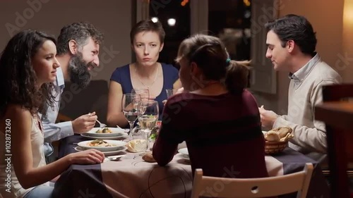 Group of young people dinning together. The camera moves. 4K, UHD