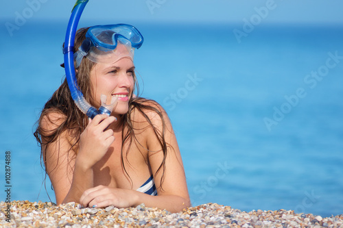 Woman on beach vacation holidays, lying in sand with snorkeling mask