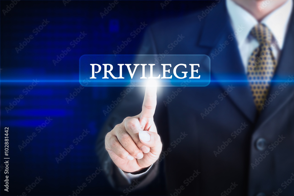 Businessman holding a white sign with the message PRIVILEGE. Can be used for your advertising. Businessman holding a white sign with the message PRIVILEGE. Can be used for your advertising.