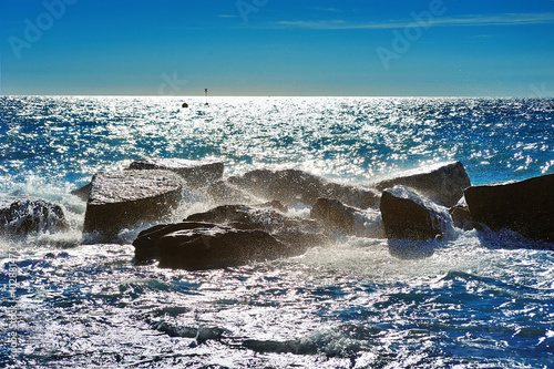 Stones in the Mediterranean Sea with waves splashes