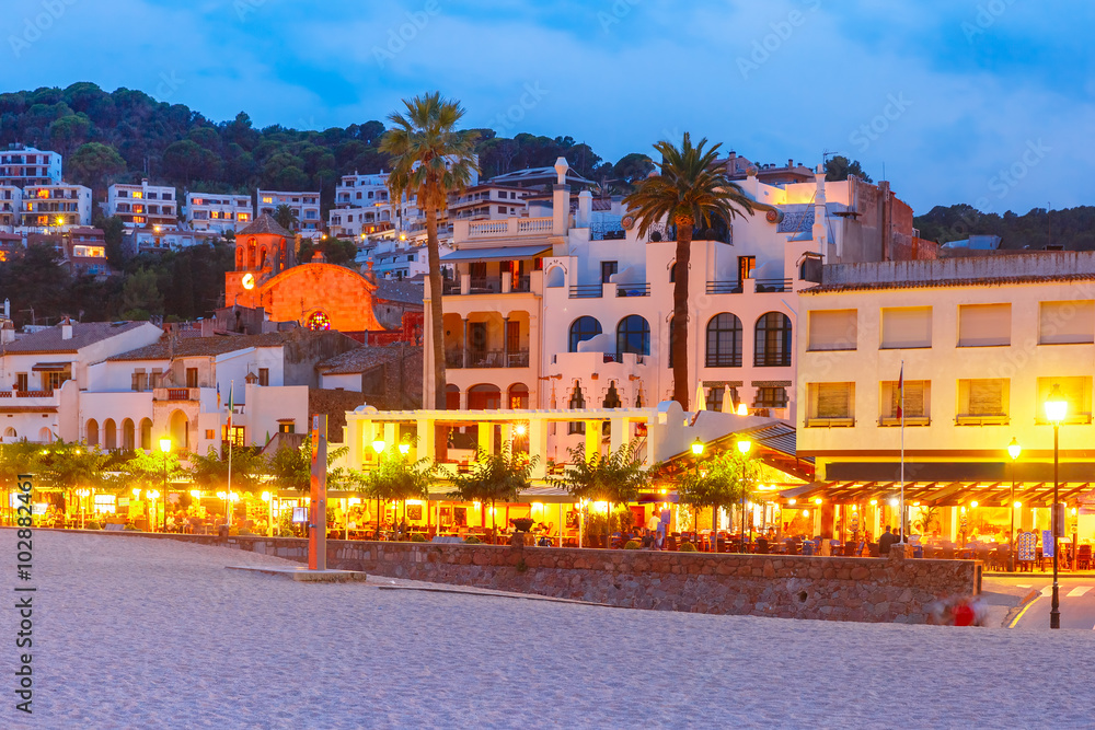 Night beach and promenade with cafes and restaurants in Tossa de Mar on the Costa Brava, Catalunya, Spain