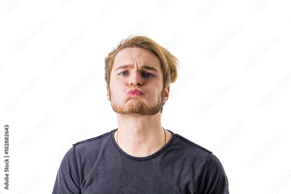 Portrait of young man blowing lips Portrait of young man blowing lips