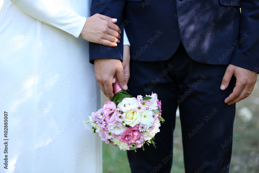 Bride and groom holding wedding bouquet Bride and groom holding wedding bouquet