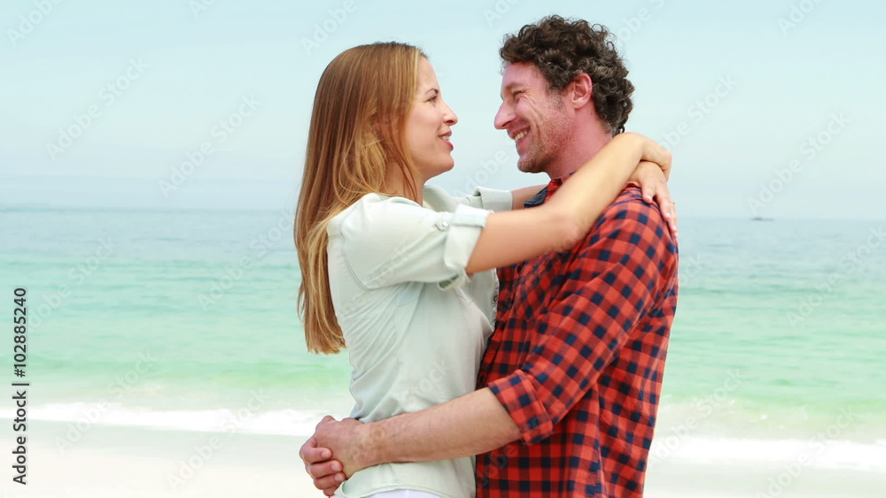 Happy couple hugging on the beach Happy couple hugging on the beach
