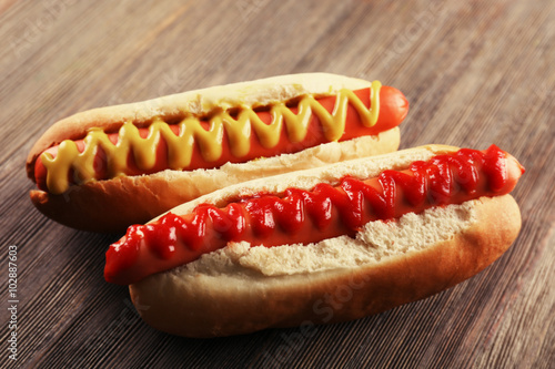 Hot dogs on wooden background, closeup