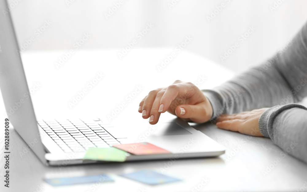 E-commerce concept. Woman with credit card and laptop, close up - obrazy, fototapety, plakaty 