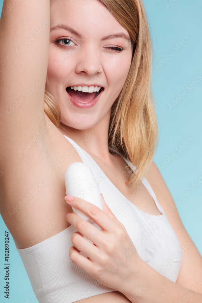 Girl applying stick deodorant in armpit. Girl applying stick deodorant in armpit.