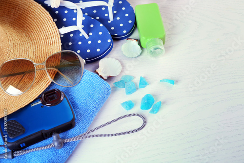 Summer accessories on wooden table, close up