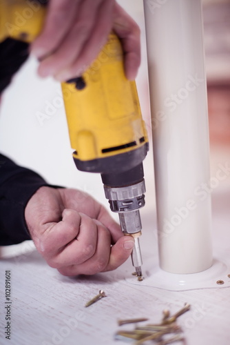 repairman working with drilling machine