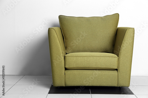 Living room interior with green armchair on white wall background