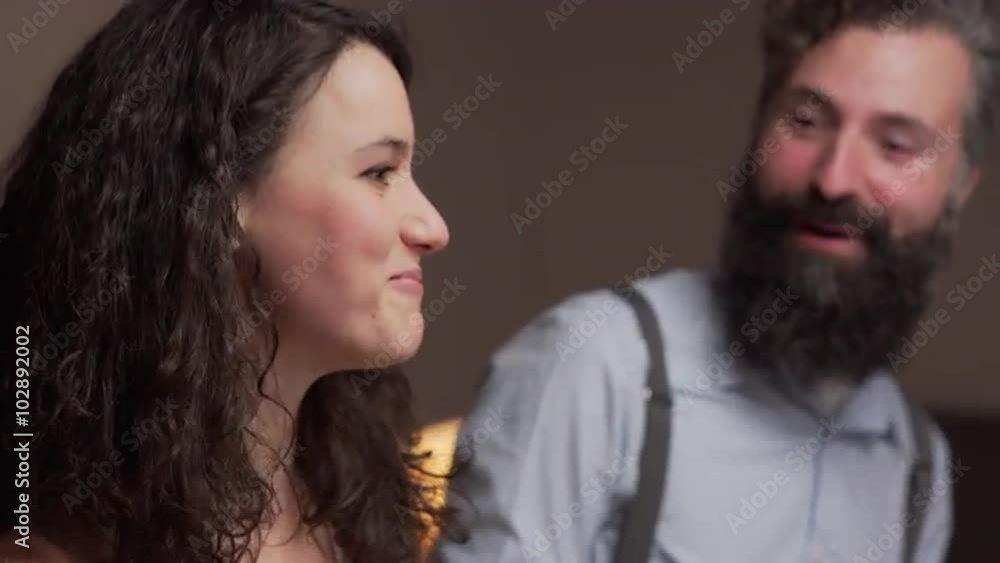 Young woman in a dinner with friends. She is talking and laughing. The camera moves. 4K, UHD Young woman in a dinner with friends. She is talking and laughing. The camera moves. 4K, UHD