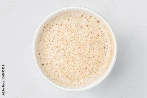 top view of paper cup mix latte coffee foam, white background