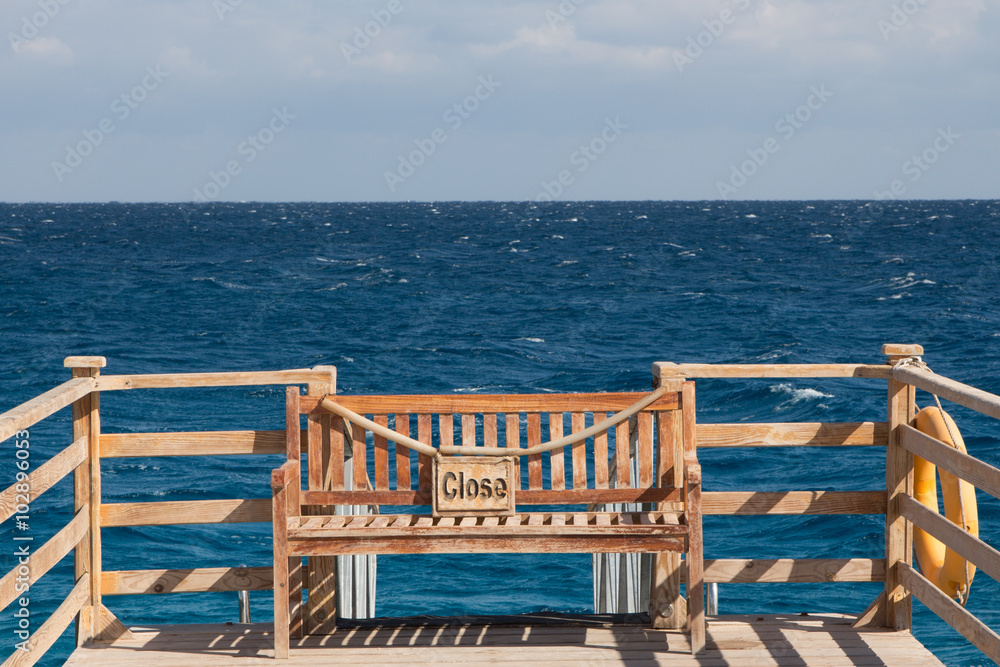 Bench on a pier with the plate 