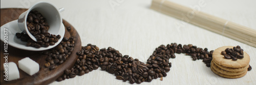 Coffee cup and coffee beans with cookies