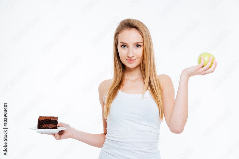 Happy beautiful woman holding chocolate cake and green apple Happy beautiful woman holding chocolate cake and green apple
