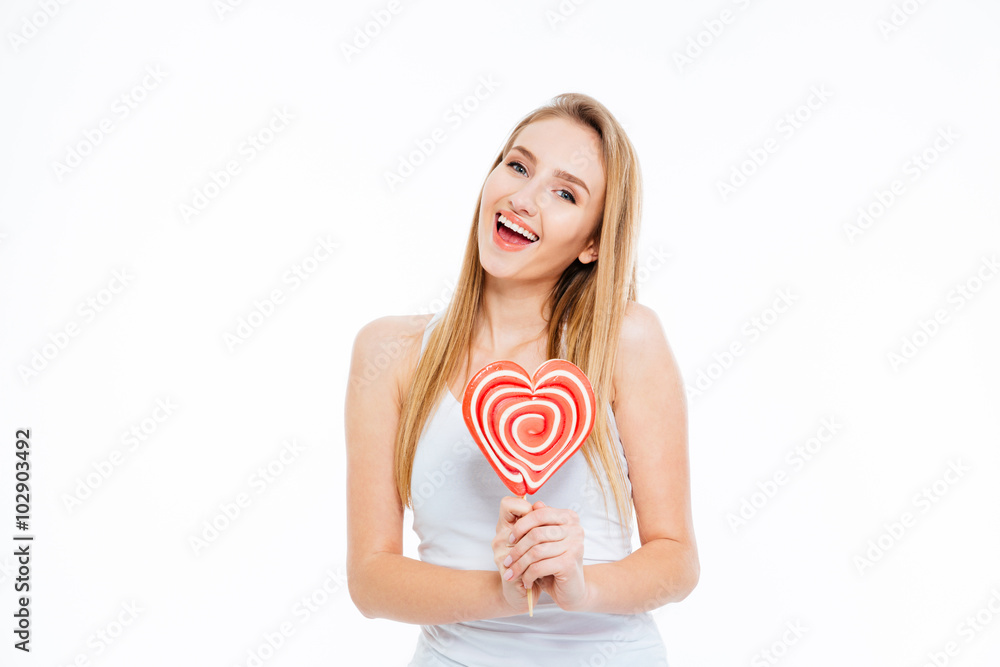 Happy woman holding heart shaped lollipop Happy woman holding heart shaped lollipop