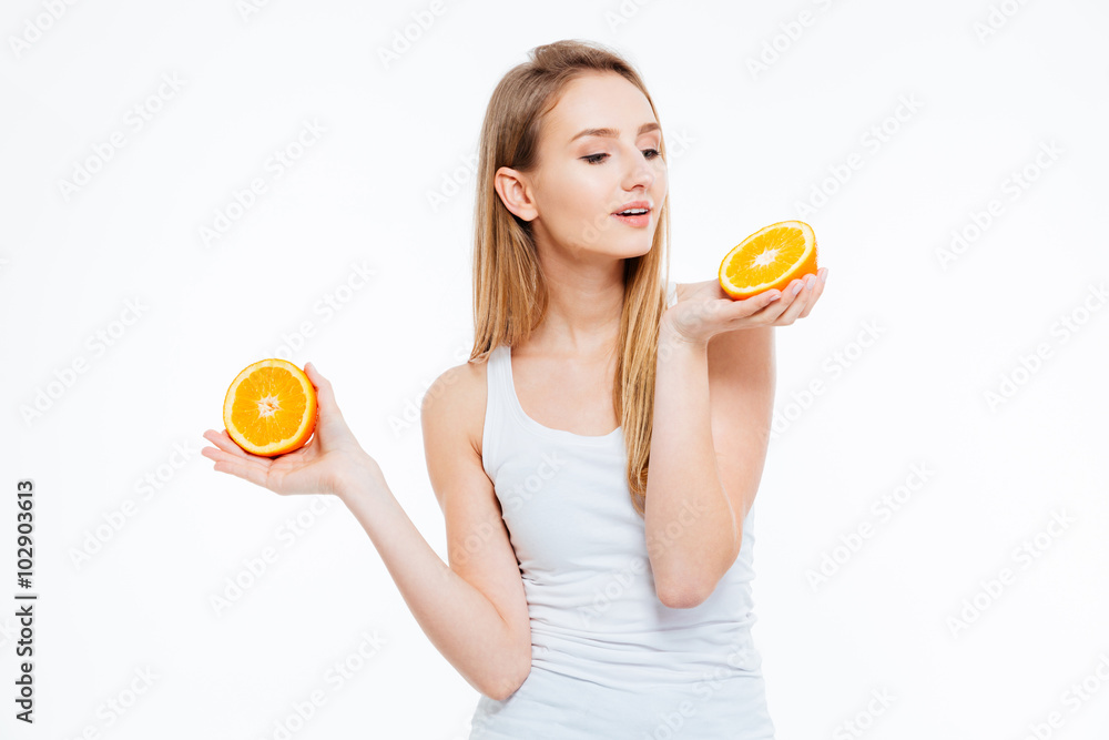 Beautiful young woman holding orange