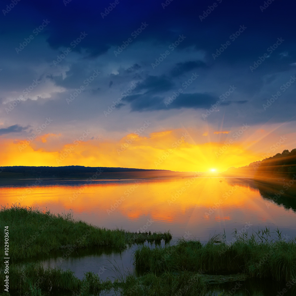 Fototapeta premium orange sunset over river