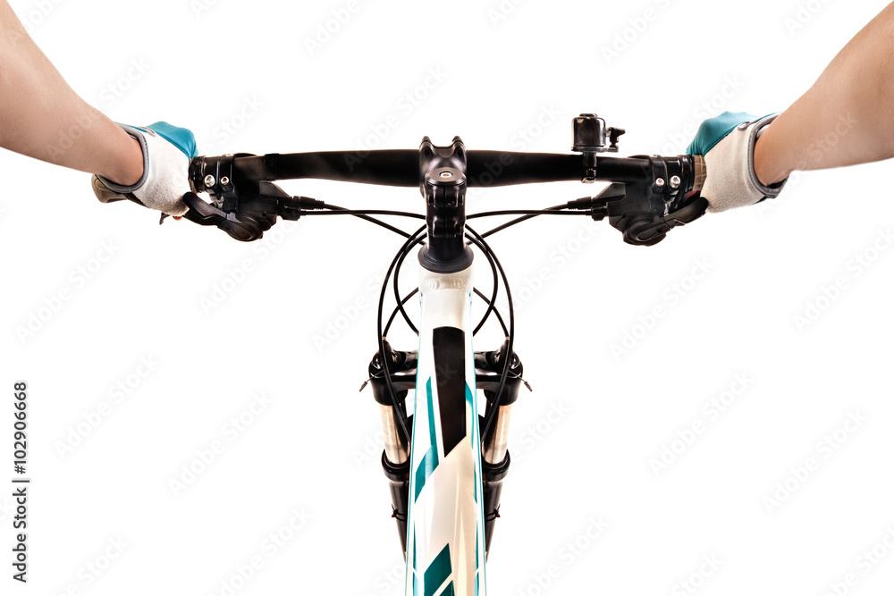 Naklejka premium Close up bicycle rider's hands on a mountain bicycle handlebar.