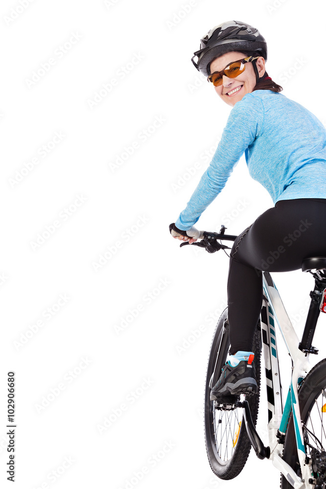 Naklejka premium Adult woman cyclist riding a bicycle looks back and smiling isolated on white background. Studio shot.
