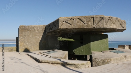 Old German WW2 canon hidden in bunker on beaches in northern France Normandy 4K 3840X2160 30fps UltraHD footage - World War 2 canon inside German bunker French beach 4K 2160p UHD video photo