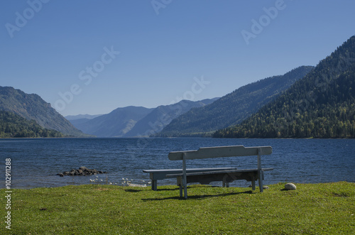 Bench by the lake in the mountains